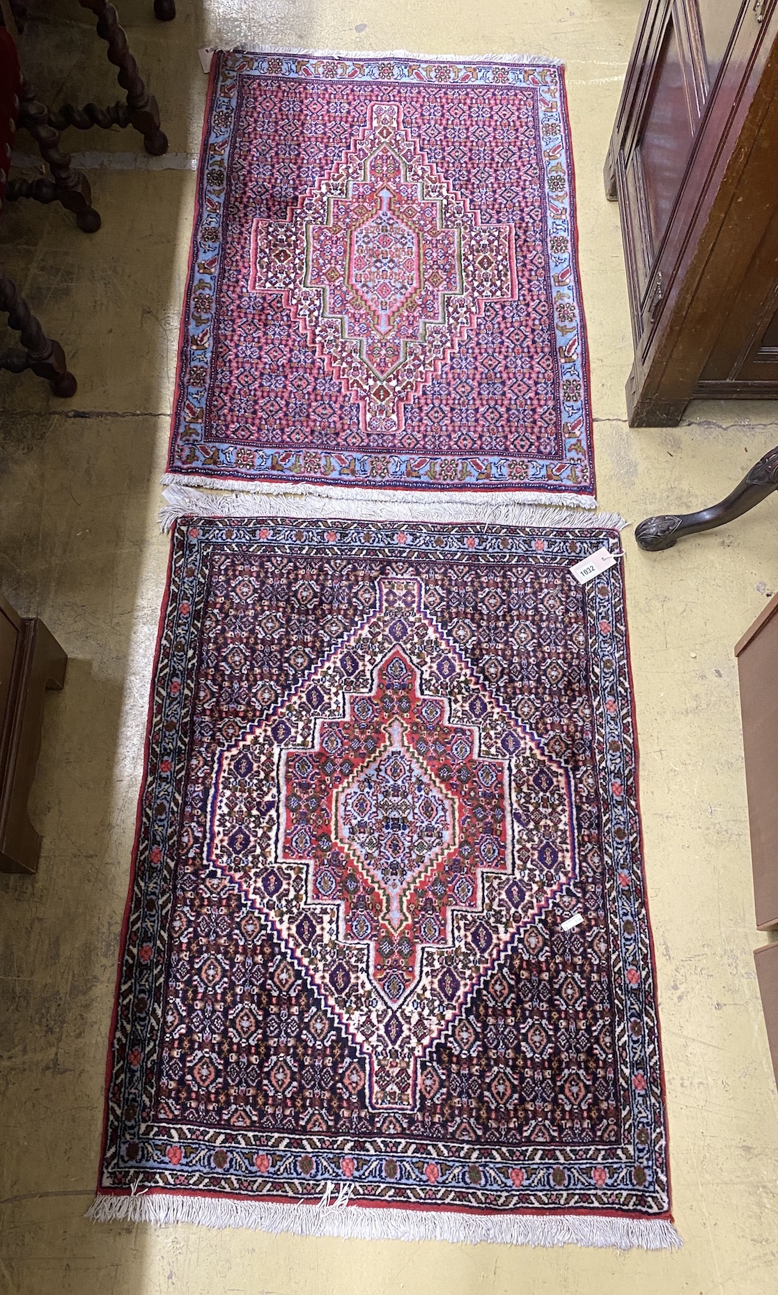 A near pair of Senneh blue ground mats, larger 104 x 77cm